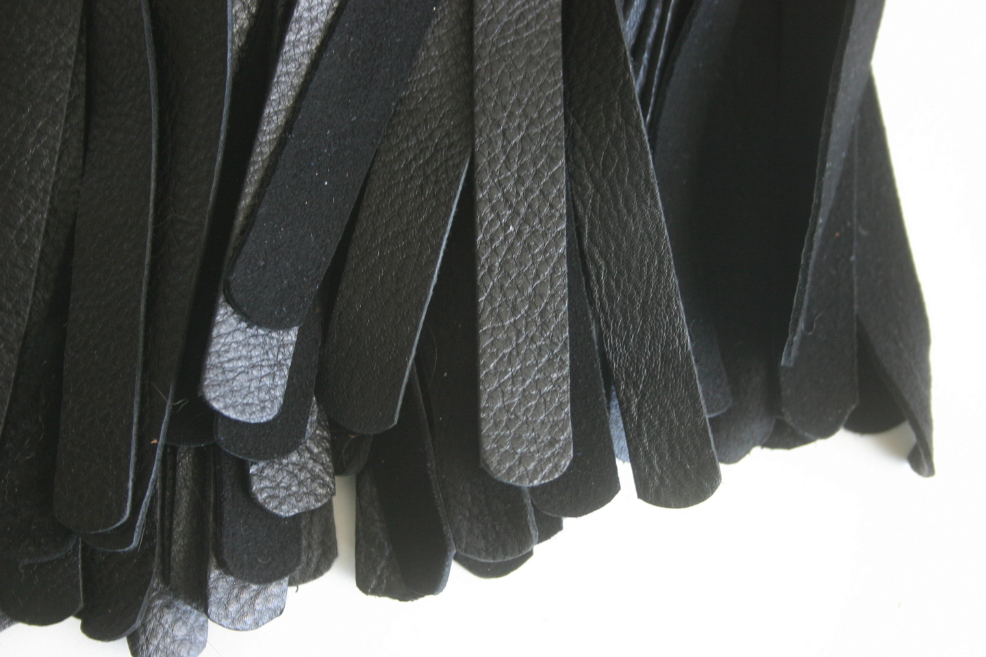 Black mop tails close up.