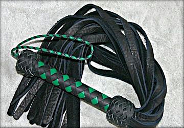 A jade green and black handled bison flogger.